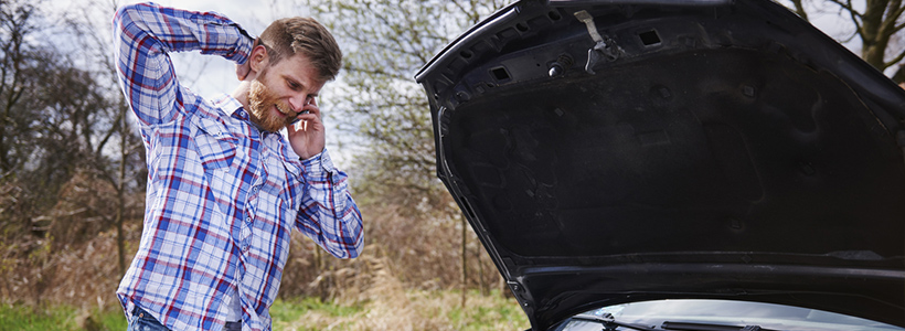 man with broken down car