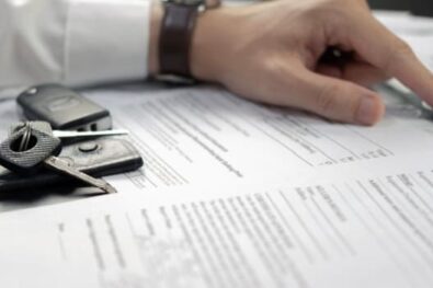 Man signing Car Insurance documents