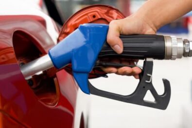 Red car at gas pump