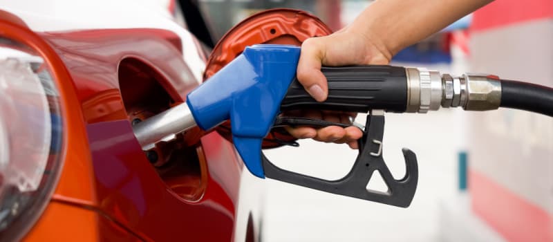 Red car at gas pump