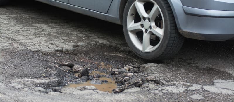 Car driving over tarmac