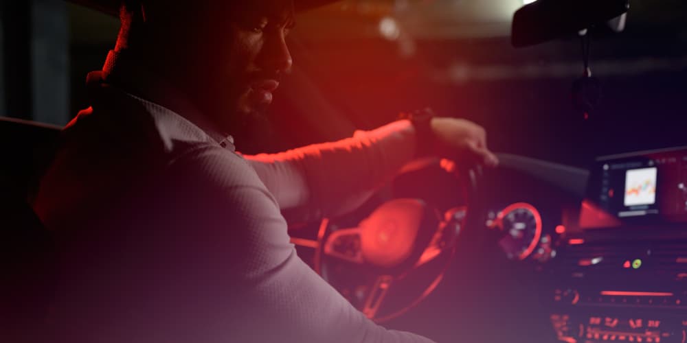 Man driving with red light effect