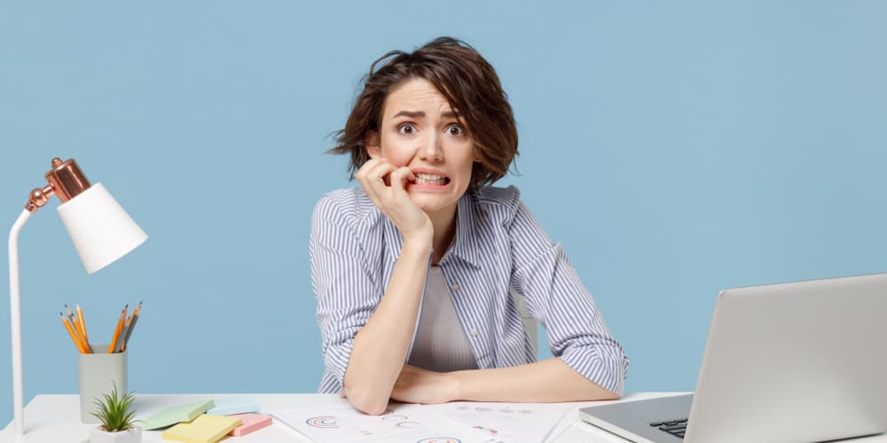 Woman stressed at desk 
