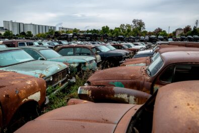 Large scrapyard with hundreds of end-of-life vehicles awaiting recycling