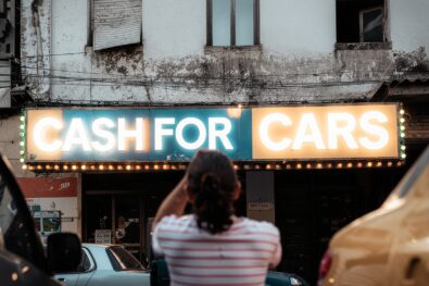 Cash for cars service sign at scrap vehicle buying centre