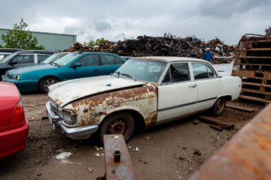 Scrap cars and metal recycling facility with end-of-life vehicles awaiting processing